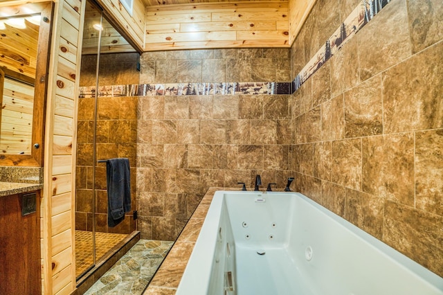 full bathroom with a shower stall and a whirlpool tub