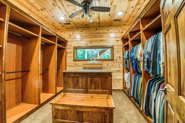 walk in closet with ceiling fan and carpet flooring