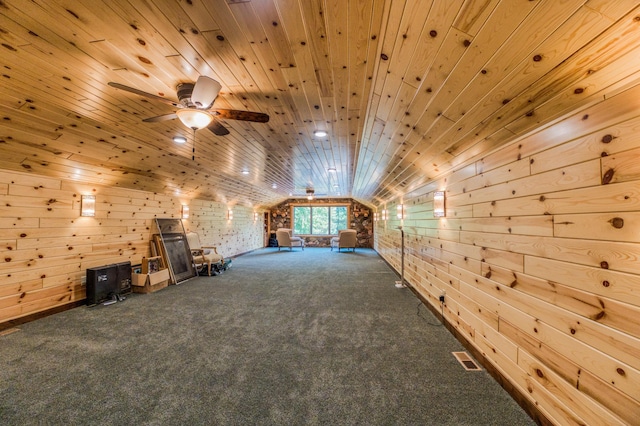 additional living space featuring lofted ceiling, wooden walls, wood ceiling, and carpet floors