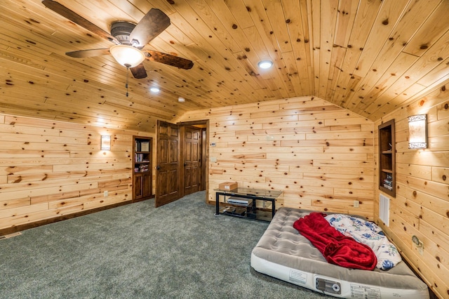 living area with ceiling fan, wood walls, wood ceiling, vaulted ceiling, and carpet flooring