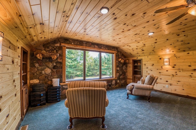 unfurnished room featuring wood walls, wooden ceiling, carpet, and vaulted ceiling