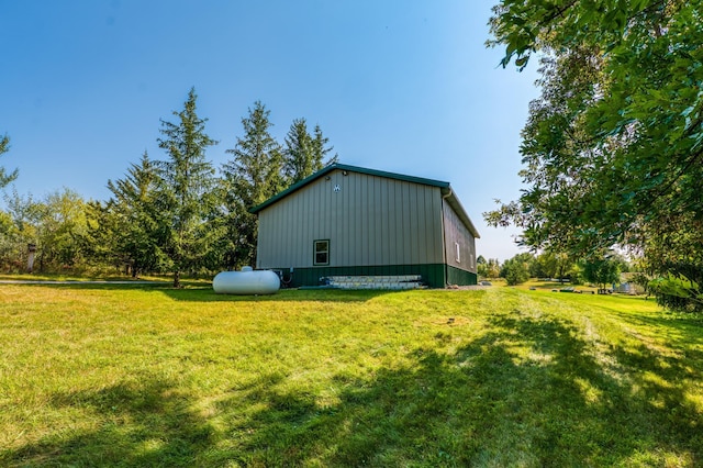 exterior space with a lawn, an outdoor structure, and a pole building