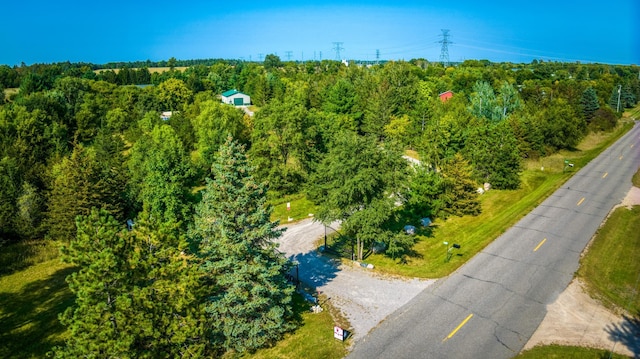 birds eye view of property with a view of trees