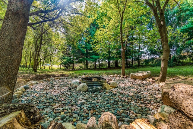 view of yard featuring an outdoor fire pit