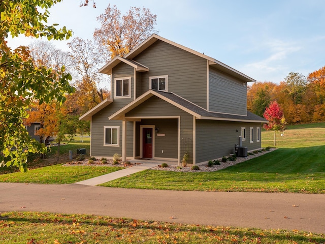 craftsman inspired home featuring central AC and a front yard