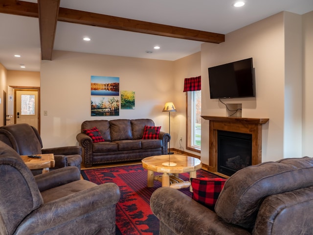 living room featuring beamed ceiling and hardwood / wood-style flooring