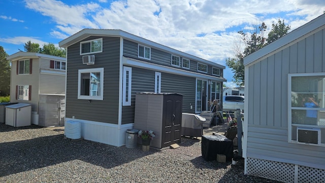 view of home's exterior featuring a wall mounted AC