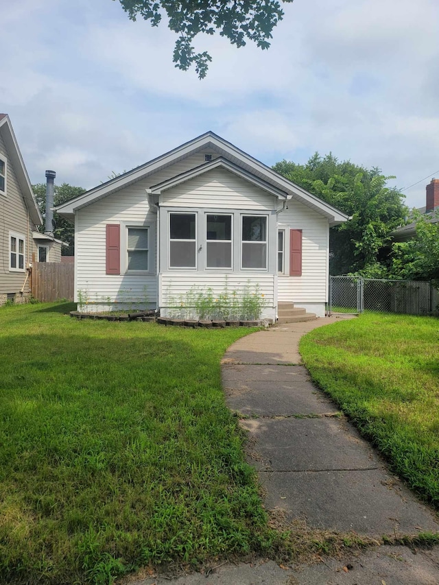 bungalow-style house with a front lawn