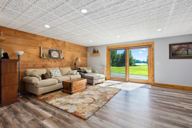 living room featuring wooden walls and hardwood / wood-style flooring