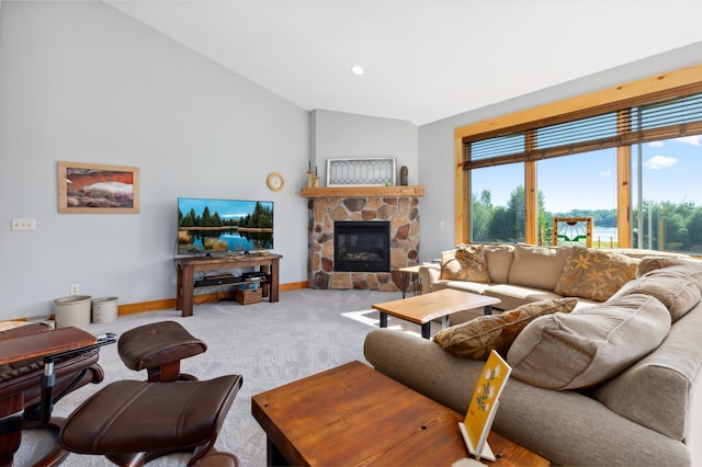 living room with carpet, a stone fireplace, and lofted ceiling