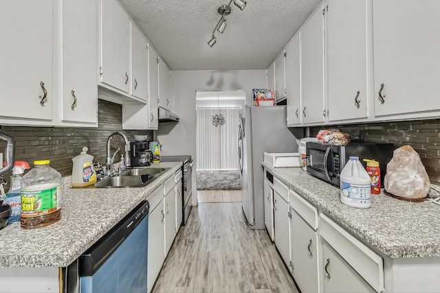 kitchen featuring appliances with stainless steel finishes, sink, white cabinets, and light hardwood / wood-style flooring