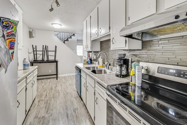 kitchen featuring appliances with stainless steel finishes, white cabinets, and sink