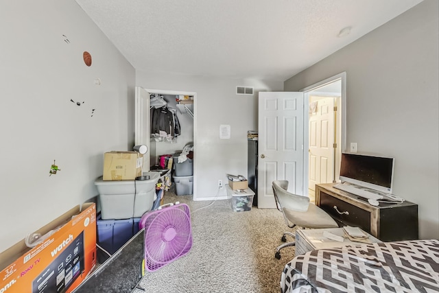 bedroom featuring carpet, a textured ceiling, and a closet