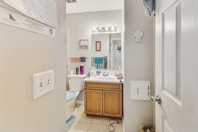 bathroom featuring vanity, toilet, and tile patterned floors