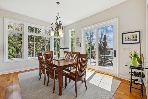 dining space with baseboards and light wood-style floors