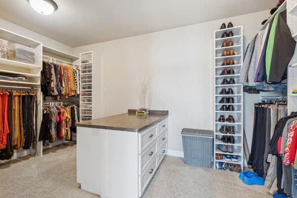 spacious closet featuring light carpet