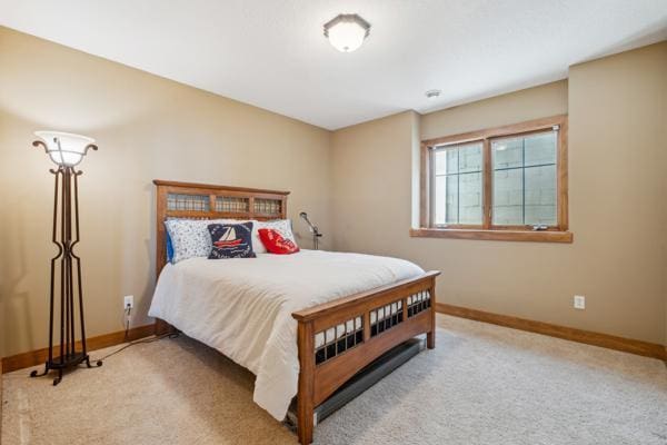 carpeted bedroom featuring baseboards