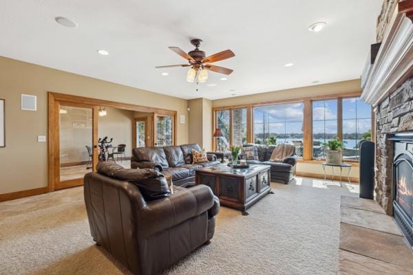 living area with ceiling fan, a fireplace, recessed lighting, baseboards, and visible vents