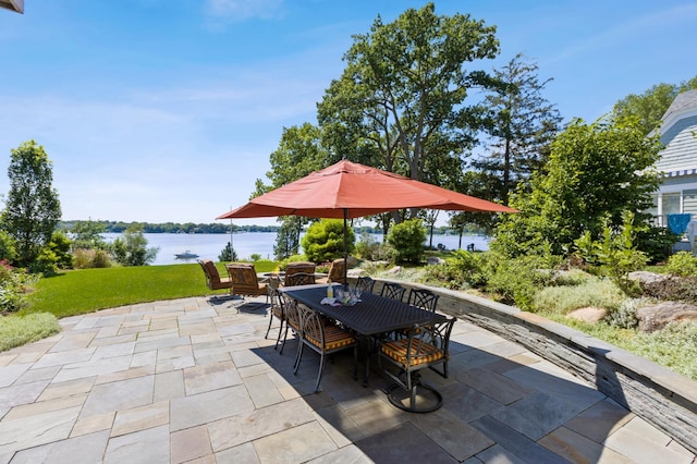view of patio / terrace with outdoor dining area and a water view