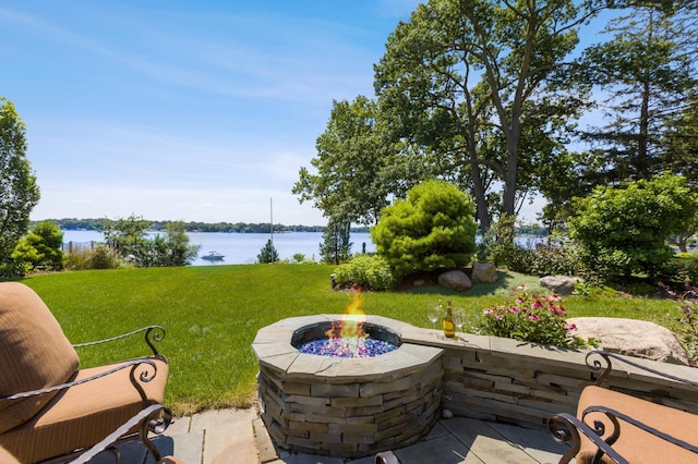 view of patio / terrace featuring a water view and an outdoor fire pit