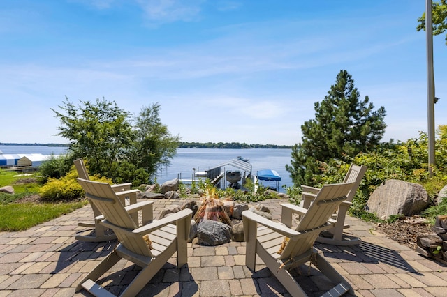 view of patio featuring a water view and a fire pit