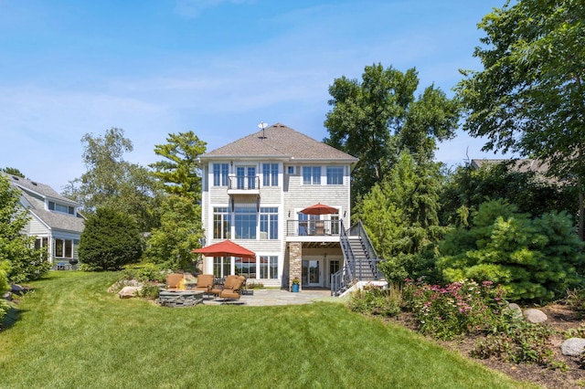 rear view of house featuring a patio, a lawn, stairway, and a deck