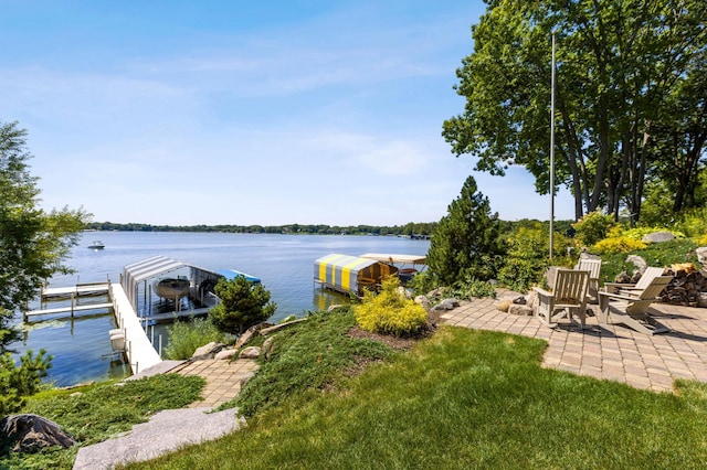 dock area featuring a water view and a patio area
