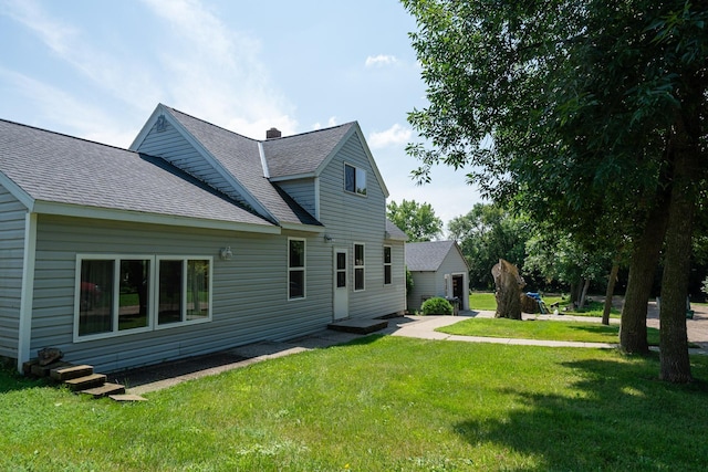 back of property featuring a yard