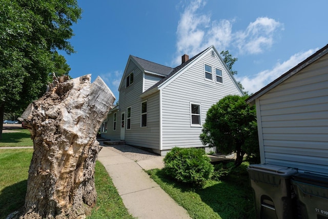 view of side of home with a lawn