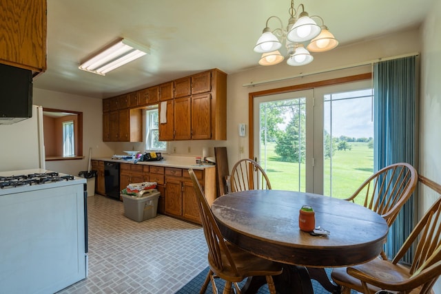 kitchen with pendant lighting, gas range gas stove, black dishwasher, and an inviting chandelier