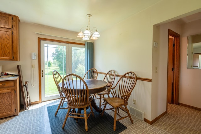 dining area with an inviting chandelier