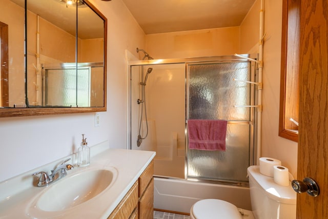 full bathroom with shower / bath combination with glass door, vanity, and toilet