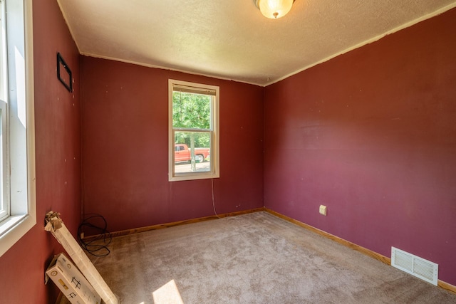 unfurnished room featuring light carpet