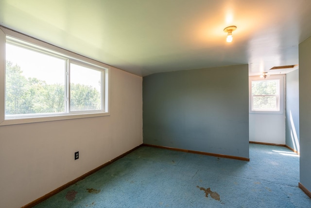 carpeted empty room with plenty of natural light