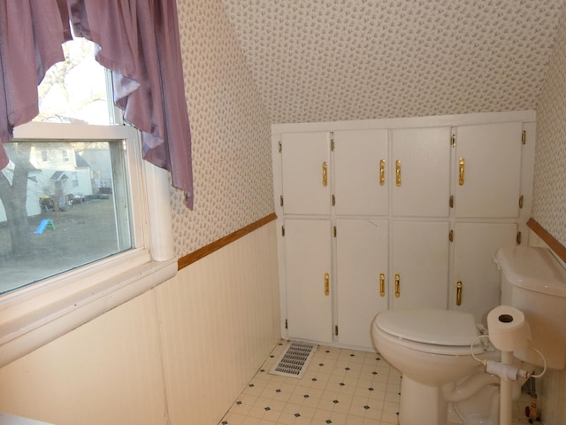 bathroom featuring plenty of natural light, tile patterned flooring, and toilet