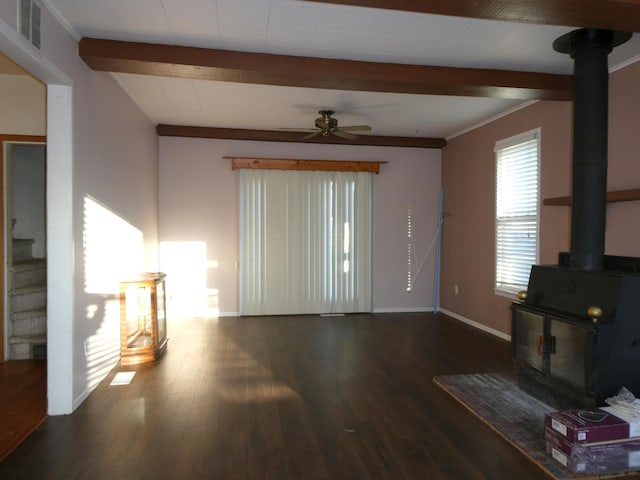 737 3rd Ave, Windom, MN 56101 - unfurnished living room with ceiling fan, visible vents, wood finished floors, a wood stove, and beam ceiling