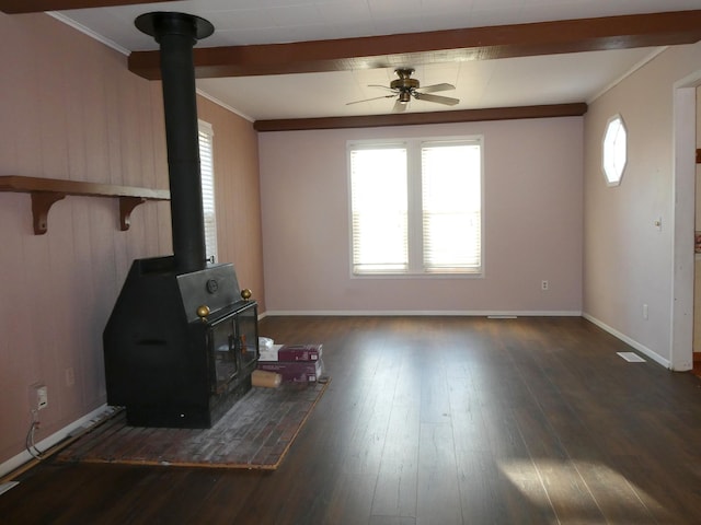 737 3rd Ave, Windom, MN 56101 - unfurnished living room featuring ornamental molding, a wood stove, ceiling fan, and baseboards