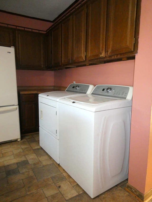 737 3rd Ave, Windom, MN 56101 - washroom with washing machine and clothes dryer, cabinet space, and stone finish floor