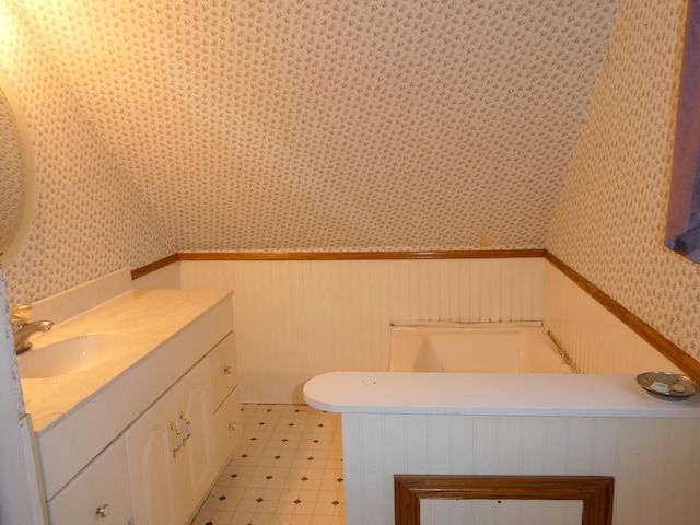 737 3rd Ave, Windom, MN 56101 - bathroom with tile patterned floors, vanity, wallpapered walls, and a wainscoted wall
