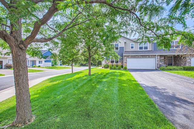 view of front facade featuring a front lawn and a garage