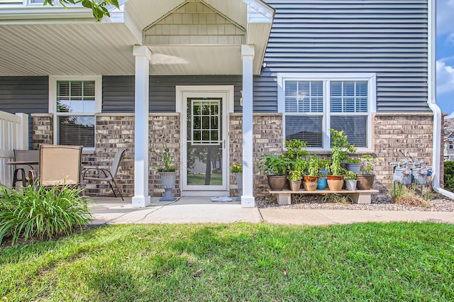 entrance to property featuring a lawn