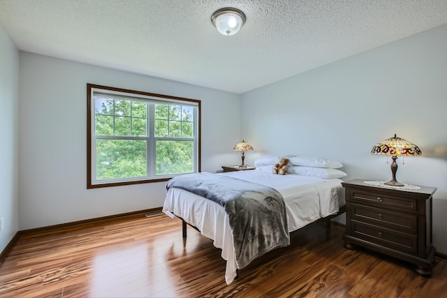 9513 Unity Ln N, Brooklyn Park, MN 55443 - bedroom with a textured ceiling, wood finished floors, and baseboards
