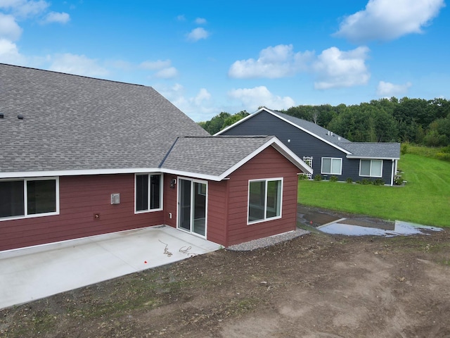 745 Hilltop Ln, Saint Croix Falls, WI 54024 - back of house with a patio, roof with shingles, and a lawn