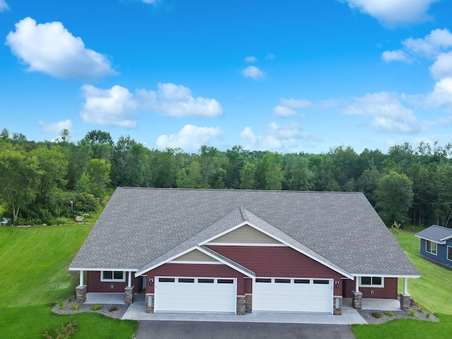 745 Hilltop Ln, Saint Croix Falls, WI 54024 - view of front of home with a garage, a front lawn, a shingled roof, and asphalt driveway