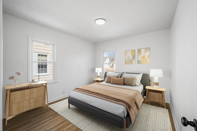 bedroom featuring wood finished floors and baseboards