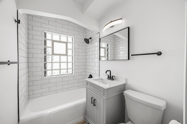 bathroom featuring vanity, toilet, and shower / bathing tub combination