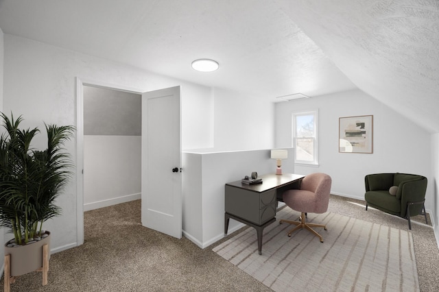 carpeted office space with a textured ceiling, baseboards, and vaulted ceiling