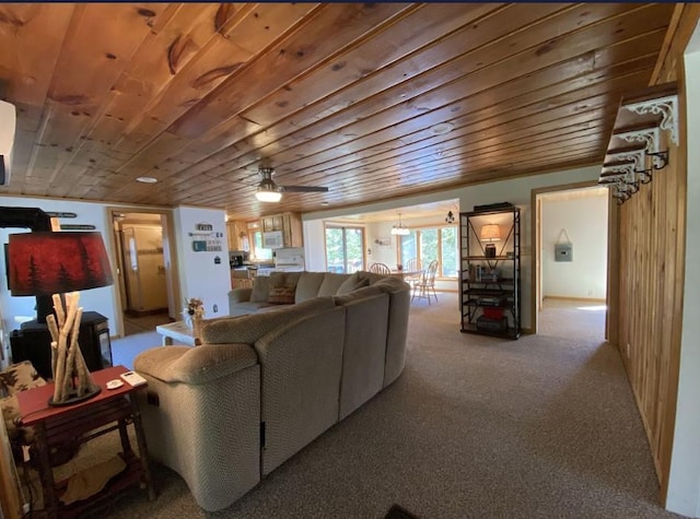 living room featuring wooden ceiling, light colored carpet, and ceiling fan