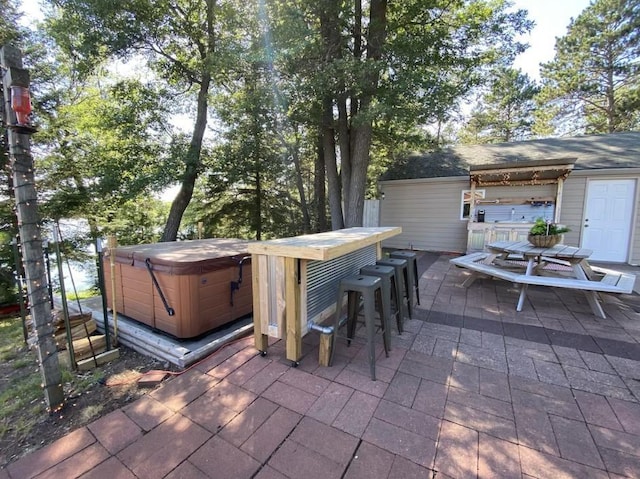 view of patio / terrace with a hot tub