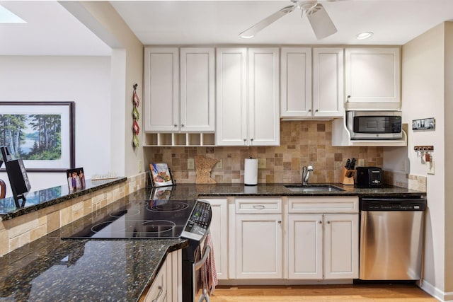 kitchen with stainless steel appliances, sink, and white cabinets